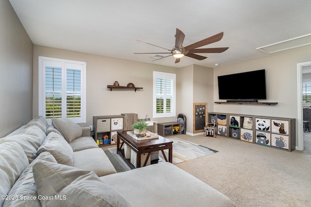 carpeted living room with a healthy amount of sunlight, a textured ceiling, and ceiling fan