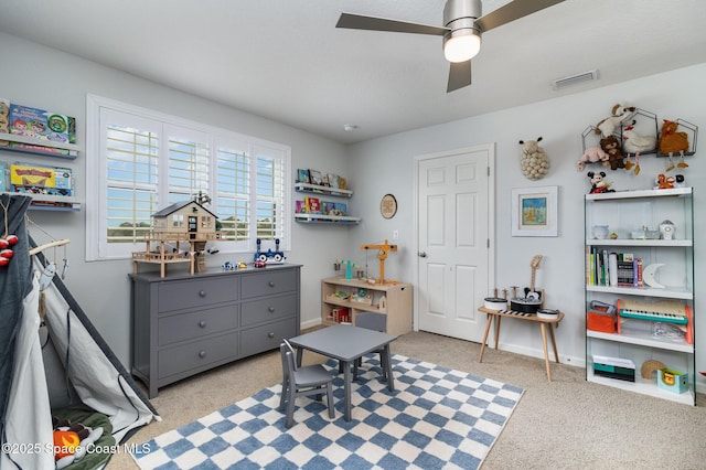 game room with light colored carpet and ceiling fan