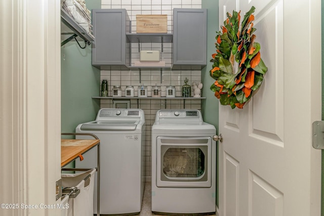 laundry area featuring washing machine and clothes dryer