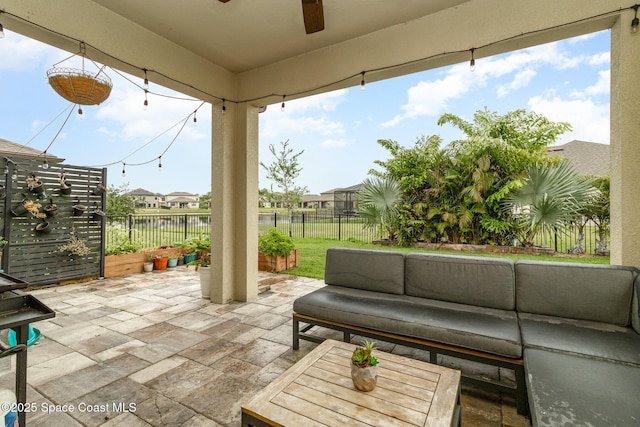 view of patio featuring a water view, an outdoor hangout area, and ceiling fan