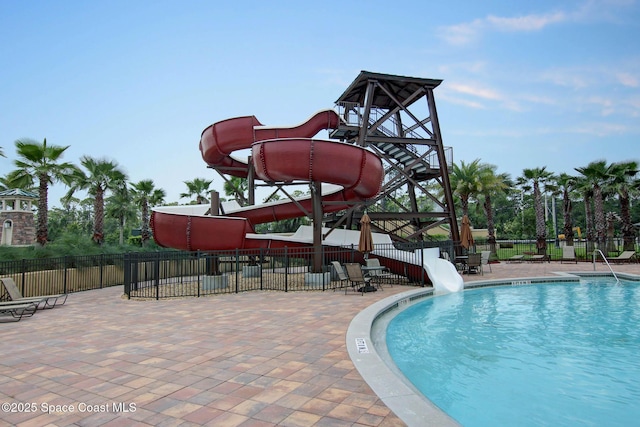 view of pool featuring a water slide and a playground