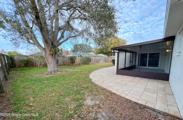 view of yard featuring a patio and a sunroom