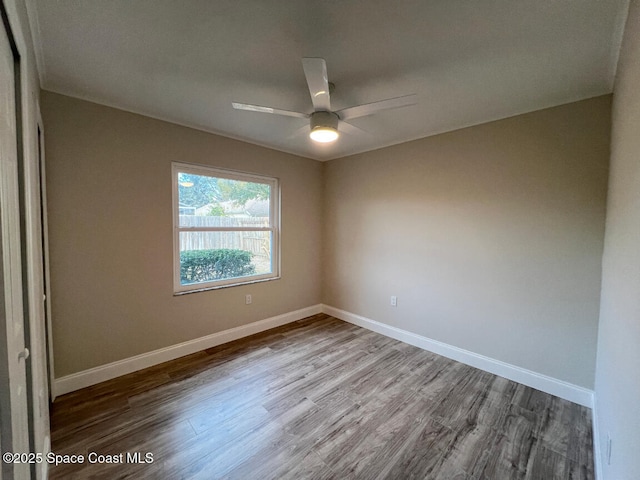 empty room with hardwood / wood-style flooring and ceiling fan