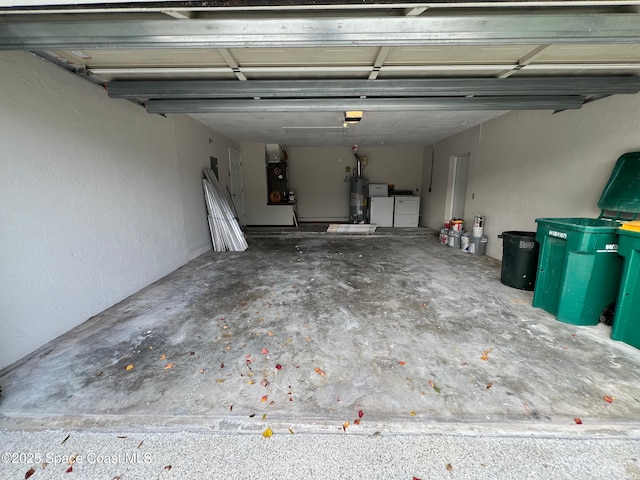 garage featuring water heater, separate washer and dryer, and a garage door opener