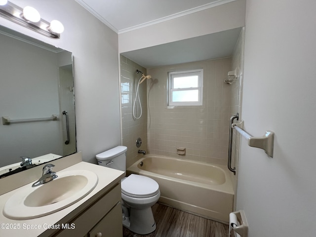 full bathroom featuring toilet, crown molding, vanity, tiled shower / bath combo, and hardwood / wood-style floors