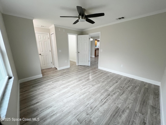 unfurnished bedroom with crown molding, light wood-type flooring, and ceiling fan