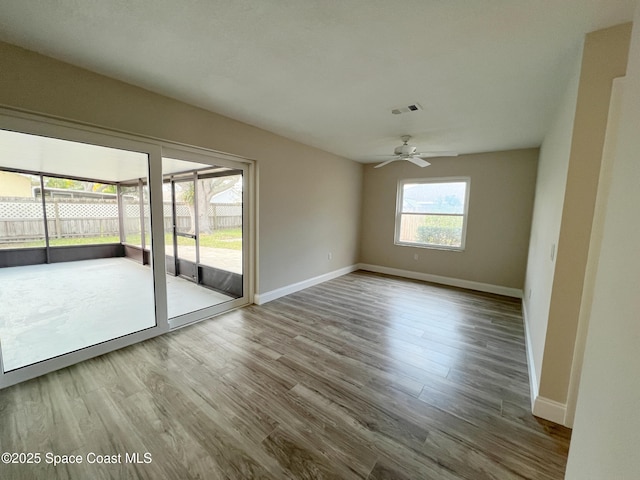 unfurnished room with ceiling fan and wood-type flooring