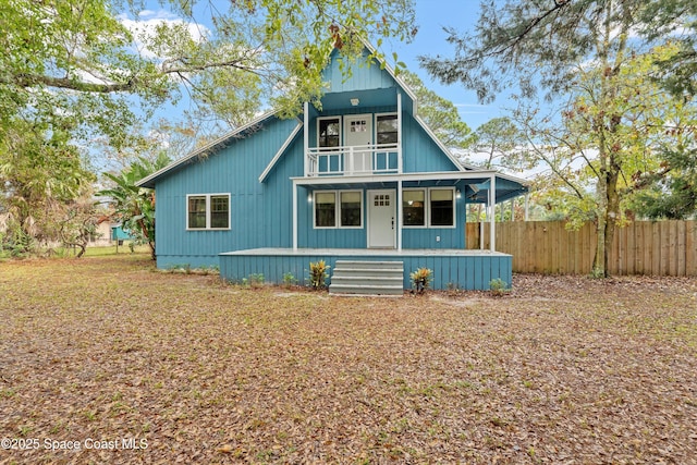 view of front of property featuring a balcony and covered porch