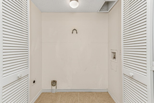 clothes washing area featuring washer hookup, hookup for an electric dryer, and a textured ceiling