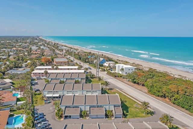 drone / aerial view featuring a water view and a beach view