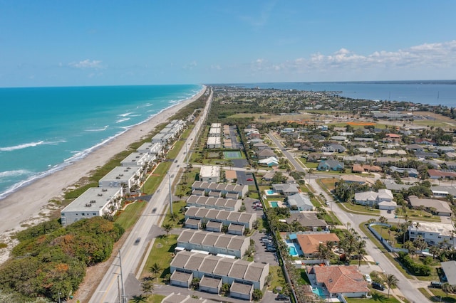 drone / aerial view with a water view and a view of the beach