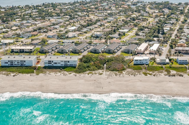 bird's eye view featuring a water view and a view of the beach