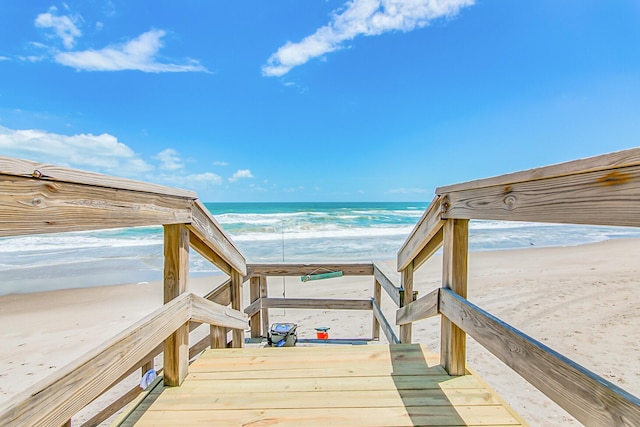 view of home's community featuring a water view and a view of the beach