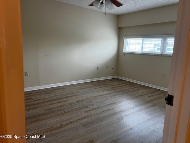 unfurnished room featuring ceiling fan, hardwood / wood-style floors, and a textured ceiling