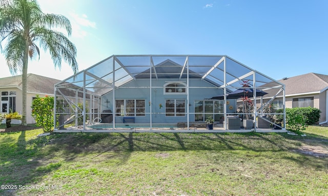 rear view of property featuring a yard