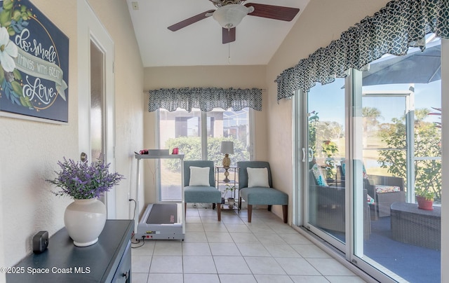 living area featuring light tile patterned flooring, ceiling fan, and lofted ceiling