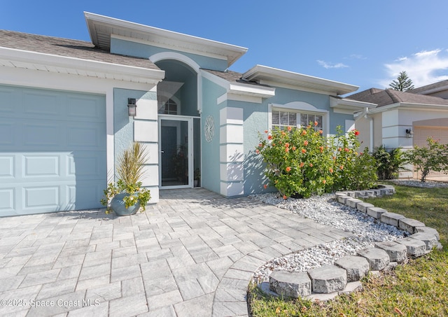 view of exterior entry featuring a garage