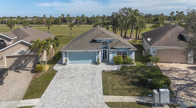 view of front of property featuring a garage and a front yard