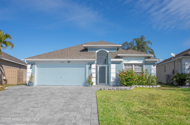 view of front facade featuring a garage and a front lawn