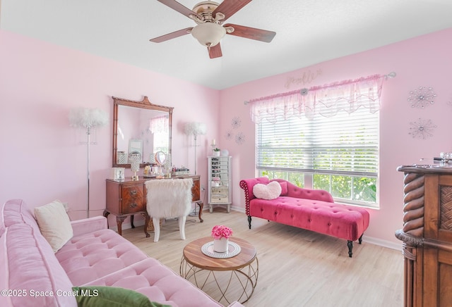 living room with light wood-type flooring and ceiling fan