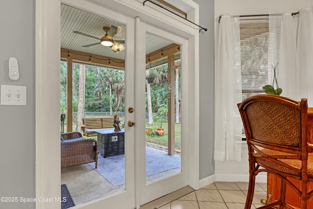 entryway with ceiling fan, a healthy amount of sunlight, and light tile patterned flooring