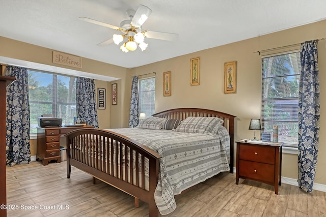 bedroom with multiple windows and ceiling fan