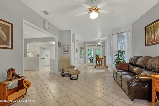 living room with light tile patterned floors and ceiling fan