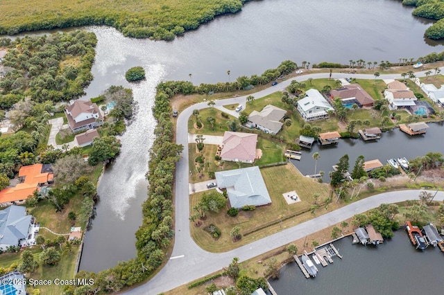 drone / aerial view featuring a residential view and a water view