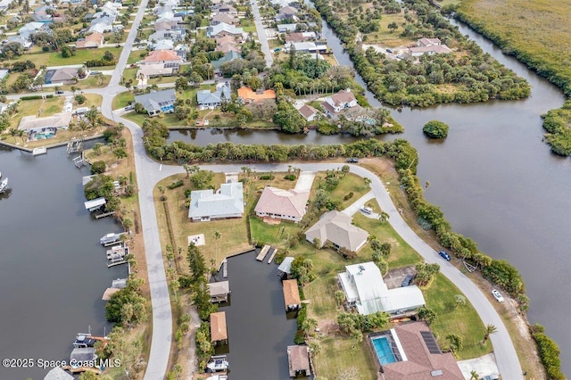 bird's eye view featuring a water view and a residential view