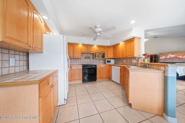 kitchen with ceiling fan, white appliances, tile countertops, and a sink