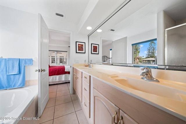 bathroom with a sink, visible vents, ensuite bathroom, and tile patterned flooring