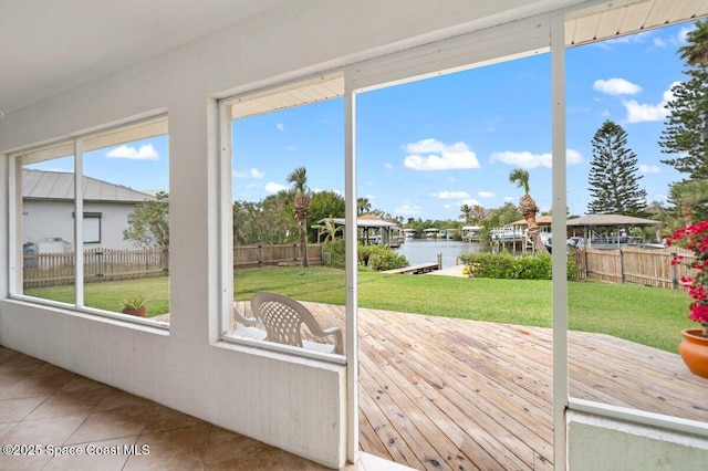 unfurnished sunroom featuring a water view and plenty of natural light