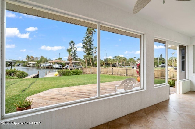 unfurnished sunroom featuring a water view