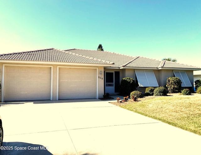 ranch-style home featuring stucco siding, driveway, a front lawn, an attached garage, and a tiled roof