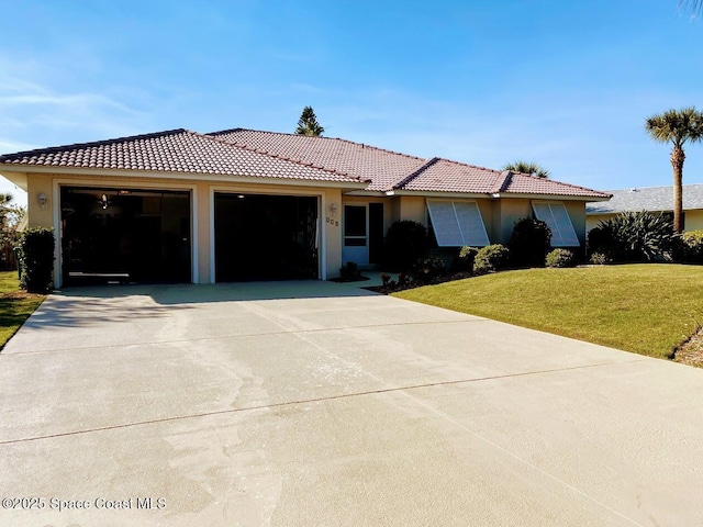 ranch-style home featuring a garage, stucco siding, concrete driveway, and a front yard