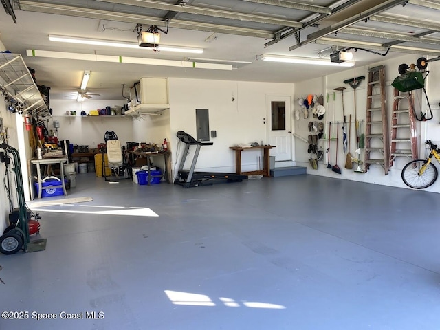 garage with electric panel and a garage door opener