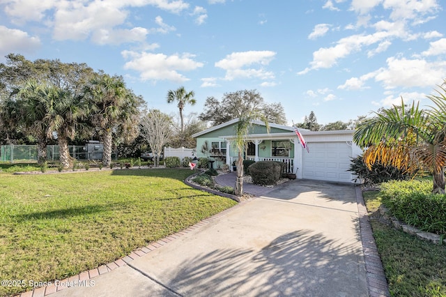 view of front of property featuring a garage, covered porch, and a front yard