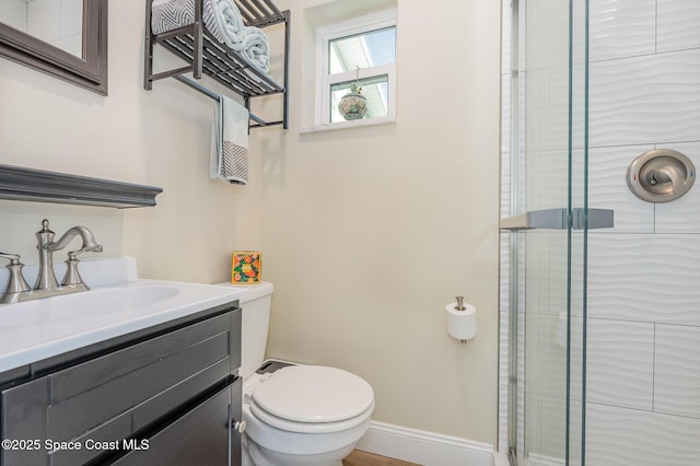 bathroom featuring walk in shower, vanity, and toilet