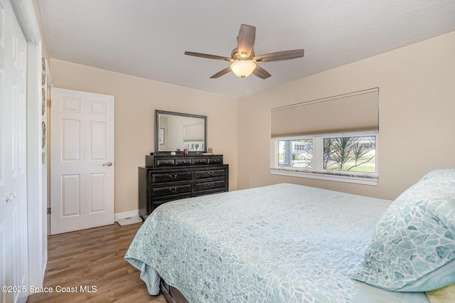 bedroom with wood-type flooring and ceiling fan