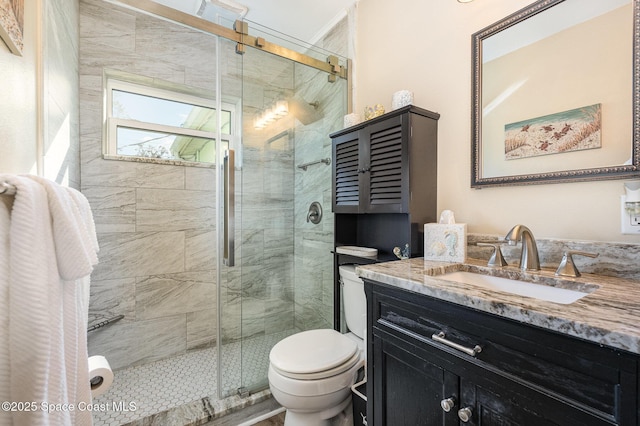 bathroom with a shower with door, vanity, and toilet