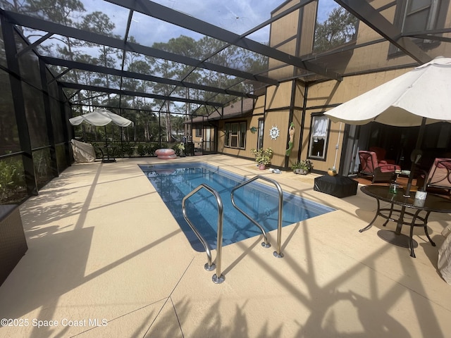 pool featuring a lanai and a patio area