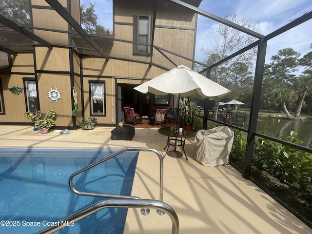 outdoor pool featuring a lanai and a patio area