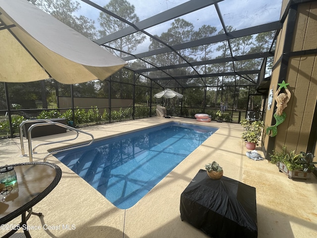 pool with a lanai and a patio