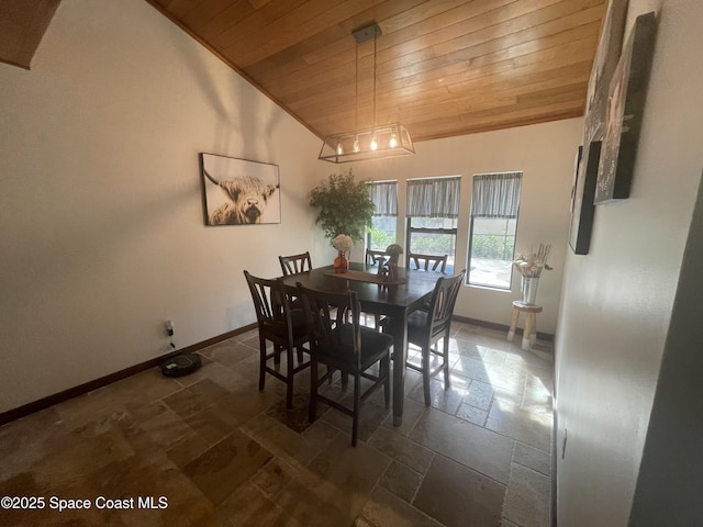 dining area featuring vaulted ceiling, wooden ceiling, stone tile flooring, and baseboards