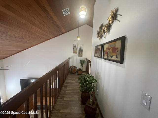 hall featuring wooden ceiling, visible vents, vaulted ceiling, and wood finished floors