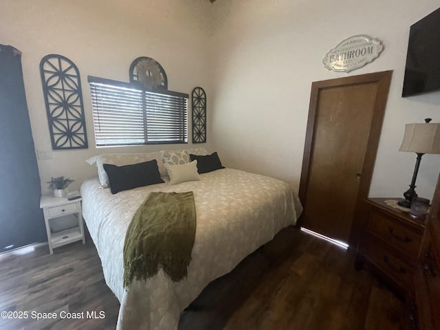 bedroom with dark wood finished floors