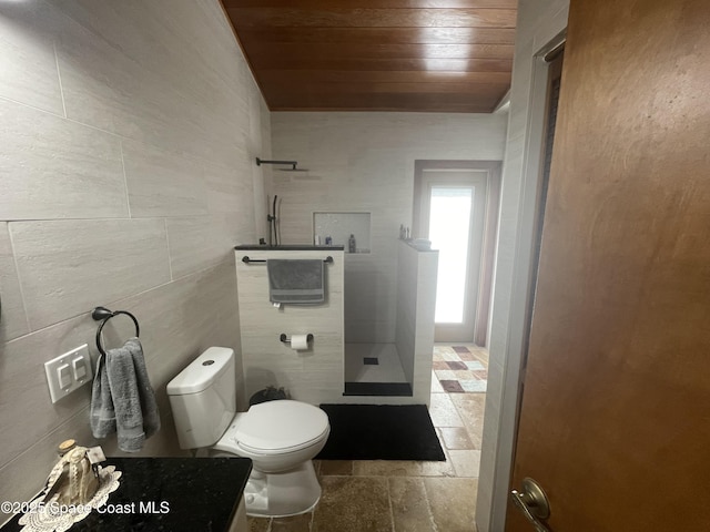 full bath with wood ceiling, tile walls, toilet, and walk in shower