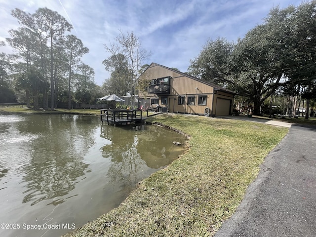 dock area featuring a water view and a yard