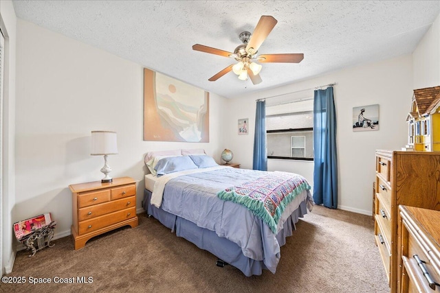 carpeted bedroom featuring ceiling fan and a textured ceiling