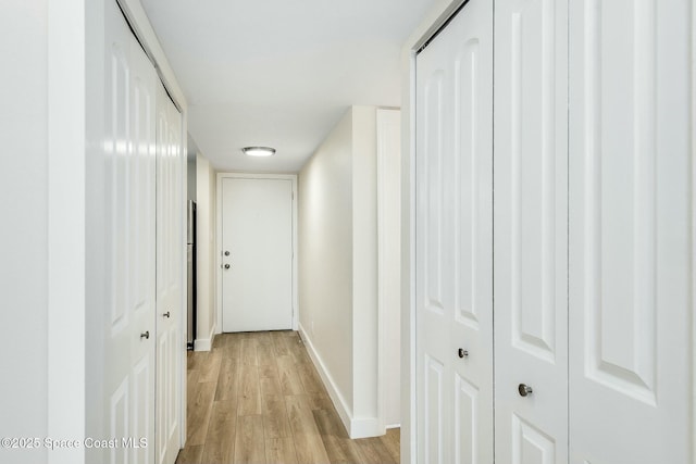 hall with light hardwood / wood-style floors